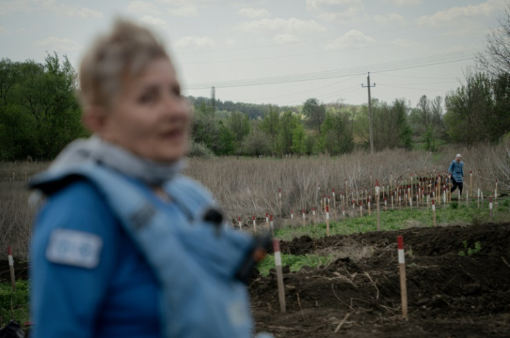 An FDS deminer working in a minefield near the Sysenkos's home in Kamyanka