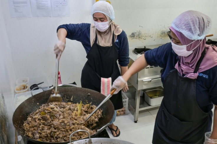 Personnel from one of the nutrition service units prepare meals for elementary and middle school students in Jakarta