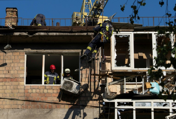 Ukrainian rescuers at a damaged residential building following the mass Russian strike on Kyiv