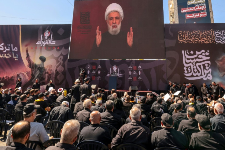 Lebanese Shiite Hezbollah supporters listen to a televised speech by the movemen't leader Naim Qassem during a ceremony during the peak of Ashura