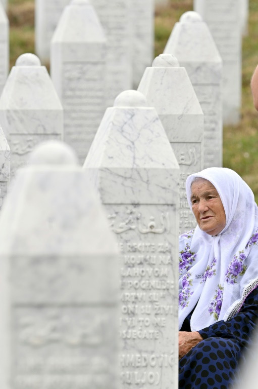 A Bosnian Muslim observes graves at the Potocari memorial cemetery outside Srebrenica, where around 8,000 people were killed three decades ago