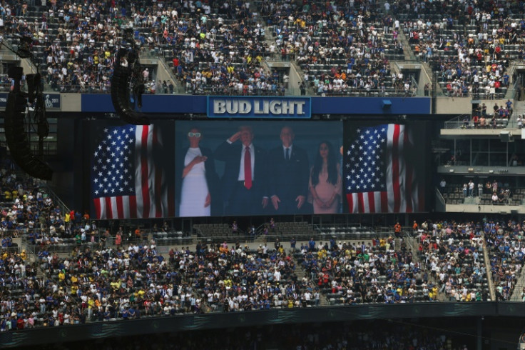 A screen shows (L-R) US First Lady Melania Trump (L), US President Donald Trump, FIFA president Gianni Infantino and his wife Leena Al Ashqar during the US national anthem ahead of the FIFA Club World Cup final