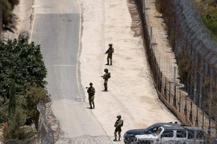 Israeli troops stand guard on the armistice line between the occupied Golan Heights and Syrian-controlled territory.