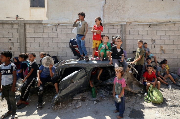 Palestinians children wait at a food distribution point in the Nuseirat refugee camp in central Gaza