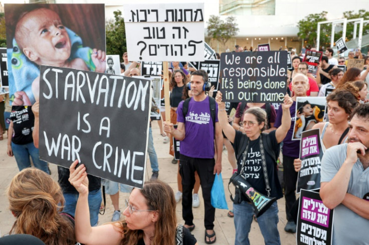 Israeli activists gather at HaBima Square for a protest march towards the Israeli defence ministry headquarters in Tel Aviv on July 22, 2025 denouncing the ongoing food shortage and forced displacement of Palestinians in the Gaza Strip