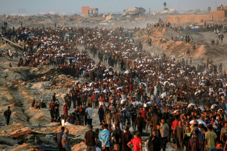 Palestinians facing deadly shortages in Gaza gather to recover food from aid convoys