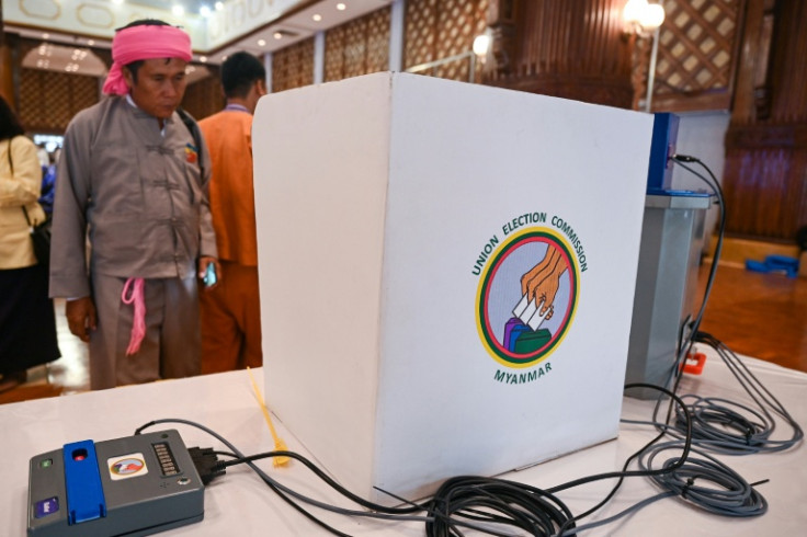 A man looks at a voting machine to be used in future elections in Yangon in 2023