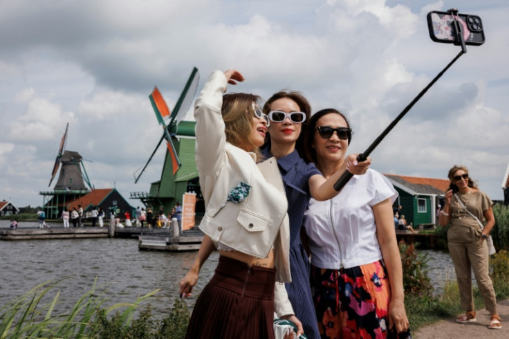 Tourists love to take selfies by windmills in Zaanse Schans