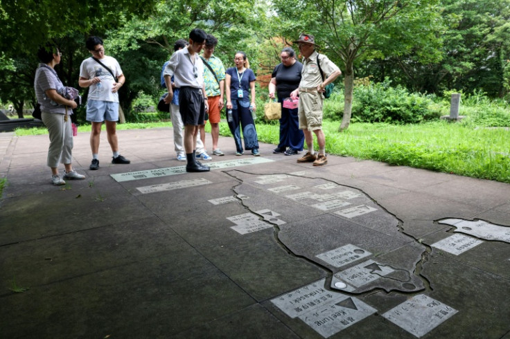 Visitors are led on a tour of Taiwan POW Memorial and Peace Park