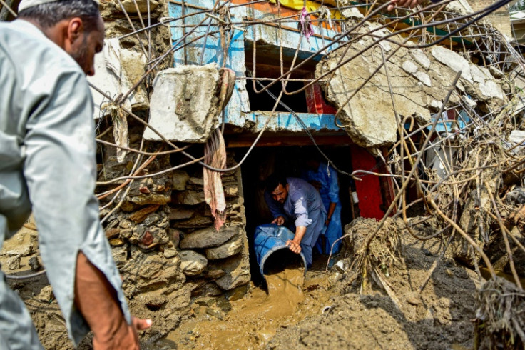 A resident removes sludge from his damaged house a day after flash floods in Buner district, located in Pakistan's mountainous Khyber Pakhtunkhwa province