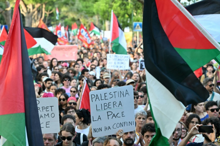 People with Palestinian flags and placards march in a demonstration in support of Gaza at the Venice film festival