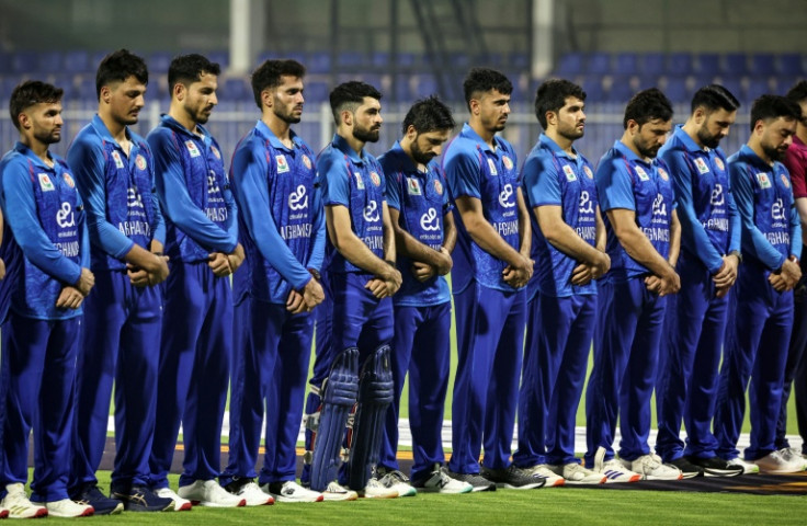Afghanistan's players observe a minute of silence for earthquake victims before the start of their T20 cricket match against the United Arab Emirates in Sharjah