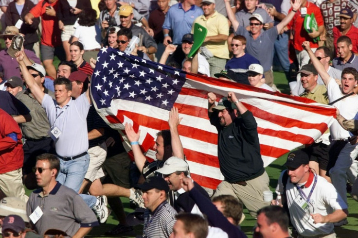 American golf fans run down the 18th fairway to celebrate the US victory in the 1999 Ryder Cup at Brookline, Massachusetts