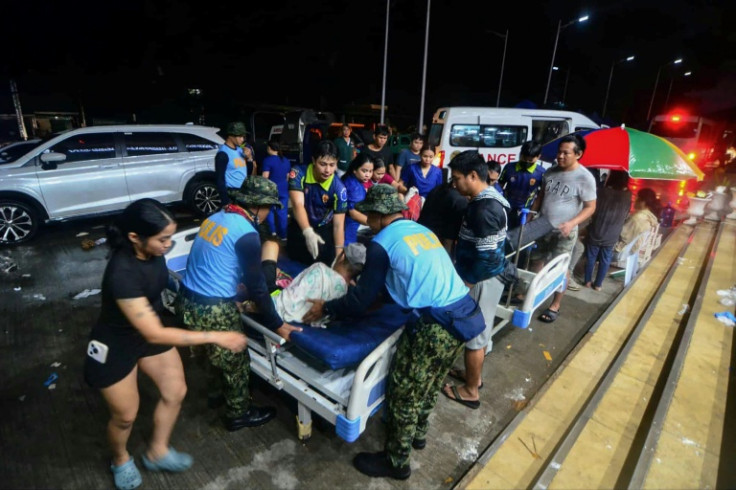 The police assist injured residents as they are brought to the hospital in Bogo City, Cebu province, central Philippines