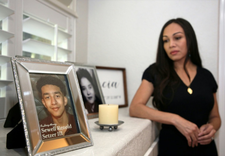Megan Garcia looks at a picture of her son Sewell Setzer III, who she says fell in love with an AI chatbot that encouraged him to take his own life