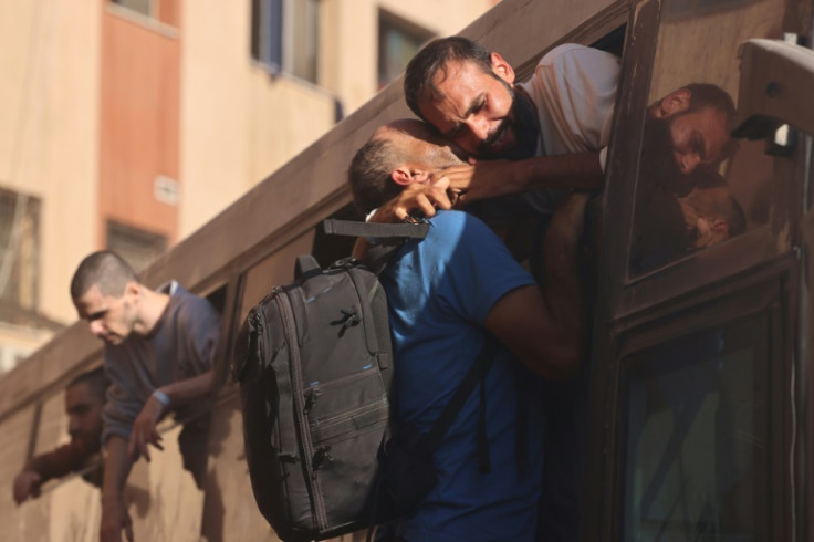 Some relatives of prisoners climbed up to the bus windows to hug loved ones spotted from the crowd
