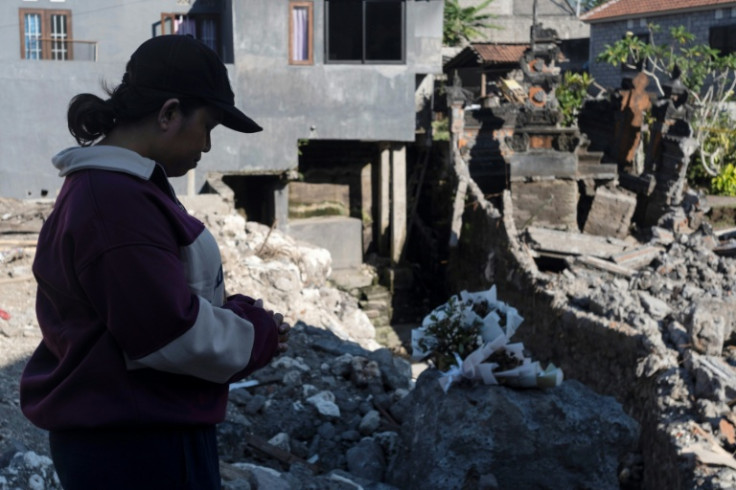 Ruth Deidree Boelan prays for her relatives who went missing in recent flooding when their home on a riverbank collapsed