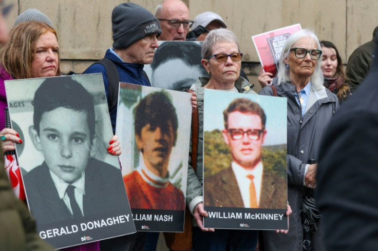 Relatives gathered outside the Belfast court at the start of the trial last month bearing posters of those killed on Bloody Sunday