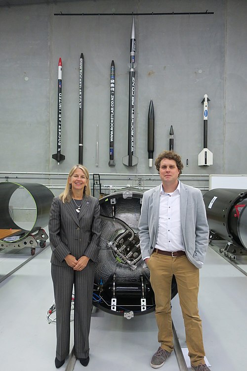 Peter Beck and Dava Newman posing in front of Rocket 