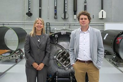 Peter Beck and Dava Newman posing in front of Rocket