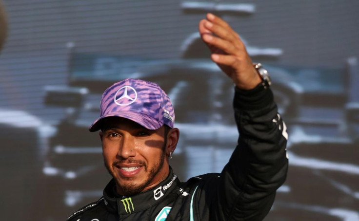 Home comfort: Lewis Hamilton celebrates after finishing first in Friday qualifying at Silverstone