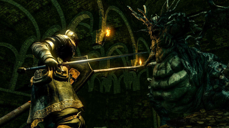 An elite knight facing off against an ancient demon in Dark Souls Remastered