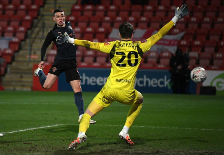 Manchester City midfielder Phil Foden (left) scores against Cheltenham in the FA Cup fourth round