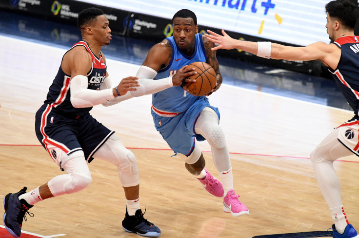  dribbles in front of Russell Westbrook #4 of the Washington Wizards 