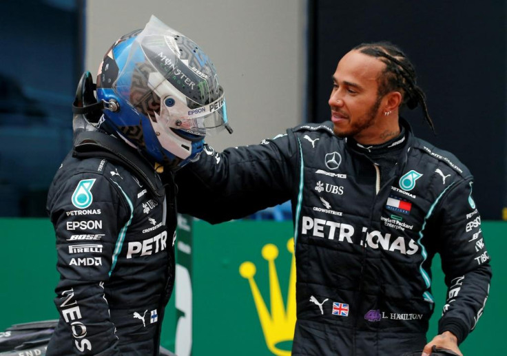 Lewis Hamilton is congratulated by Mercedes teammate Valtteri Bottas after winning a seventh drivers' crown
