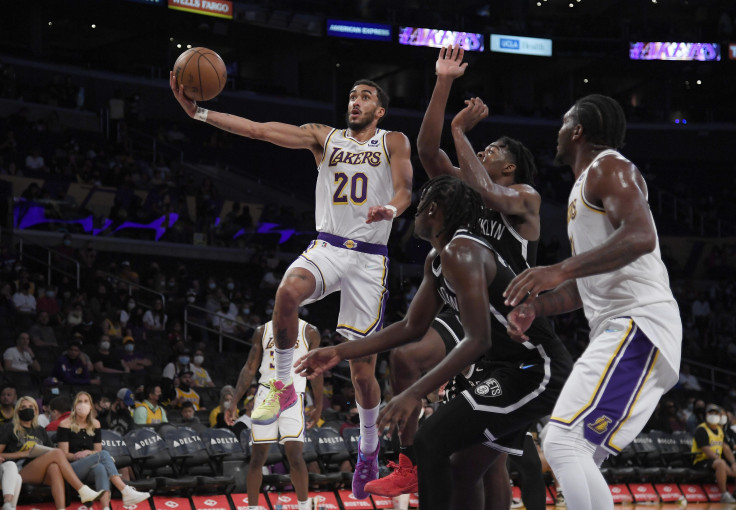 Trevelin Queen #20 of the Los Angeles Lakers goes up for a basket against Sekou Doumbouya #45 and Day'Ron Sharpe #20 of the Brooklyn Nets