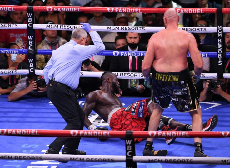Tough man: US challenger Deontay Wilder is knocked down by WBC heavyweight champion Tyson Fury of Britain as they fight for the WBC Heavyweight title in Las Vegas