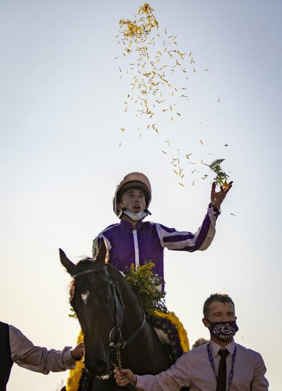 Pierre-Charles Boudot, riding Order of Australia, celebrates after winning the Breeders' Cup Mile at Keenland in Lexington, Kentucky