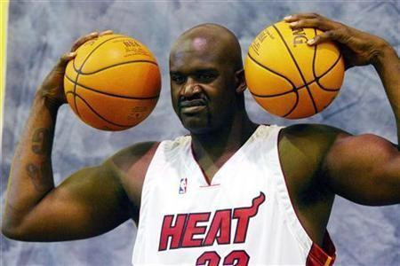 Miami Heat center Shaquille O'Neal smiles as he poses for photographers during media day in Miami, Florida