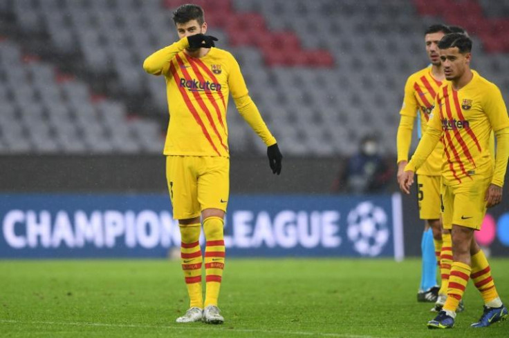 Gerard Pique (L) and Philippe Coutinho at the end of Barcelona's 3-0 defeat at the hands of Bayern Munich that sent them packing from the Champions League
