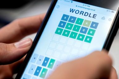 (FILES) In this file illustration photo taken on January 11, 2022 a person plays online word game "Wordle" on a mobile phone in Washington, DC. The New York Times announced on January 31, 2022 that it had bought Wordle, a phenomenon played by millions ju