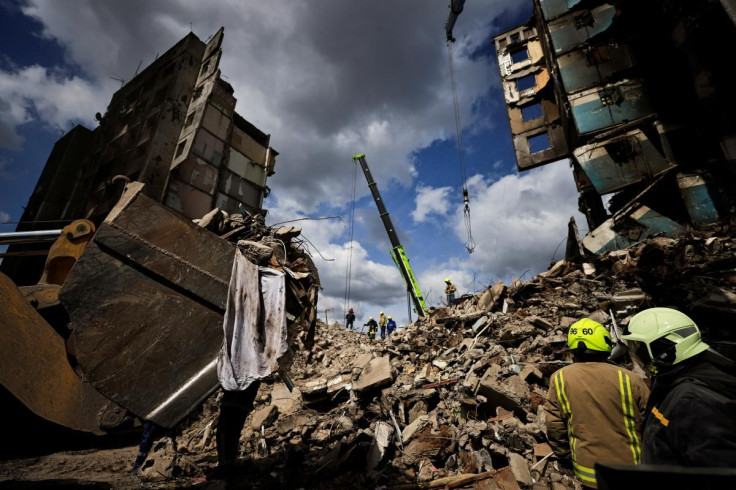 Rescuers search for bodies under the rubble of a building destroyed by Russian shelling, amid Russia's Invasion of Ukraine, in Borodyanka