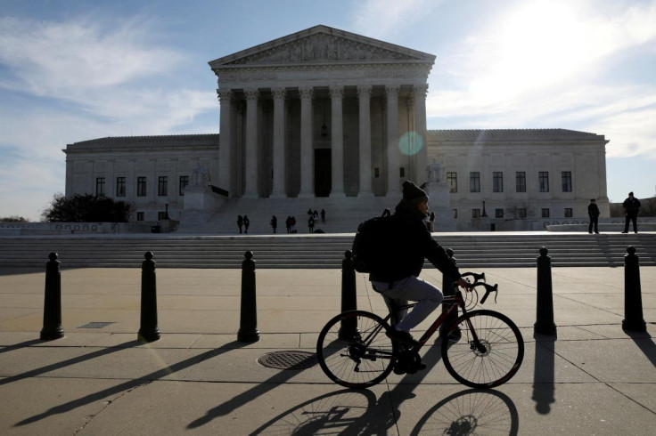 Cyclist rides in front of the U.S. Supreme Court building in Washington