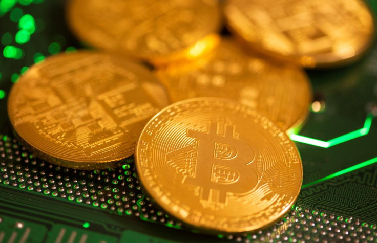 Illustration of representations of virtual currency Bitcoin on a computer motherboard