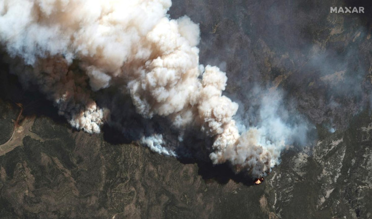 A satellite image shows a natural color view of active fire lines from the Hermits Peak and Calf Canyon fires, in New Mexico