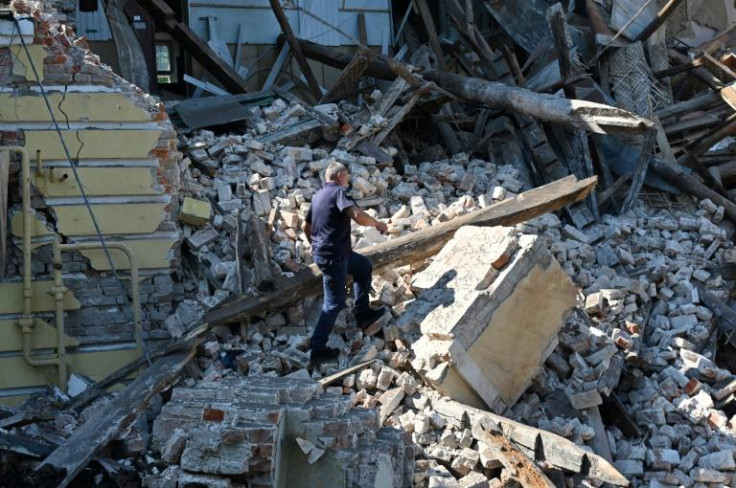 A resÑuer works among ruins of an administrative building destroyed by Russian missiles in the northeastern Ukrainian city of Kharkiv