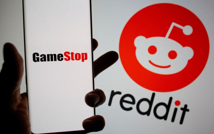 GameStop logo is seen in front of displayed Reddit logo in this illustration
