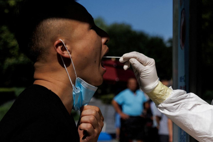 A man gets a swab test at a nucleic acid testing station, following a coronavirus disease (COVID-19) outbreak, in Beijing
